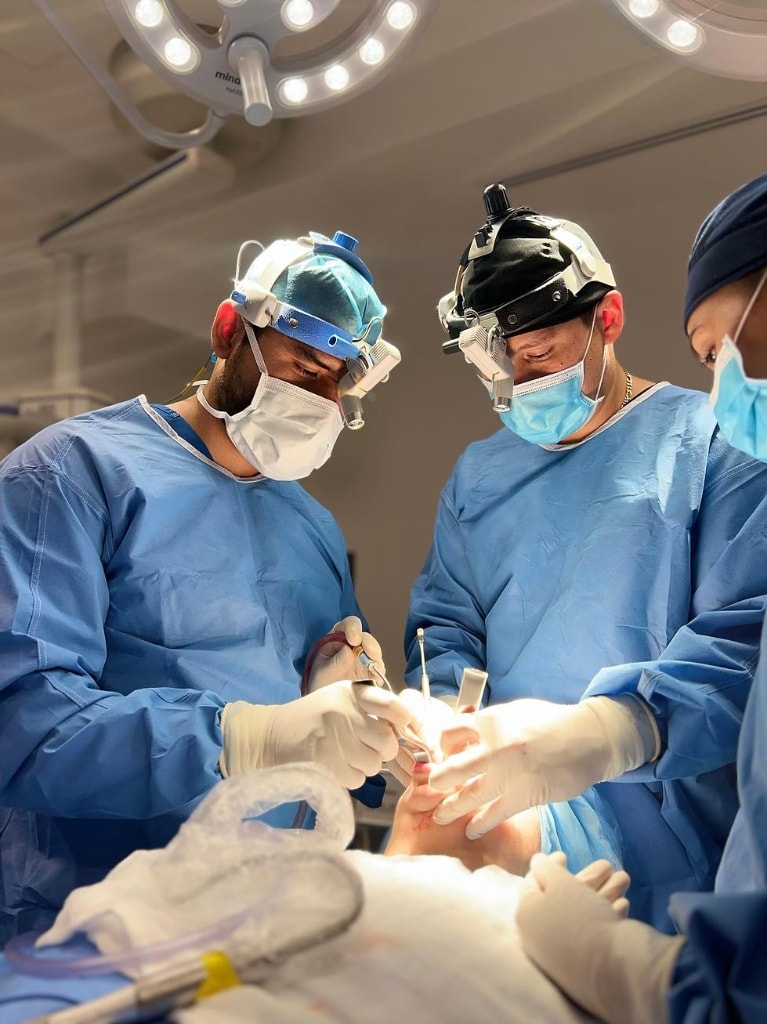 Dr. Varad performing maxillofacial surgery in the operating theatre.